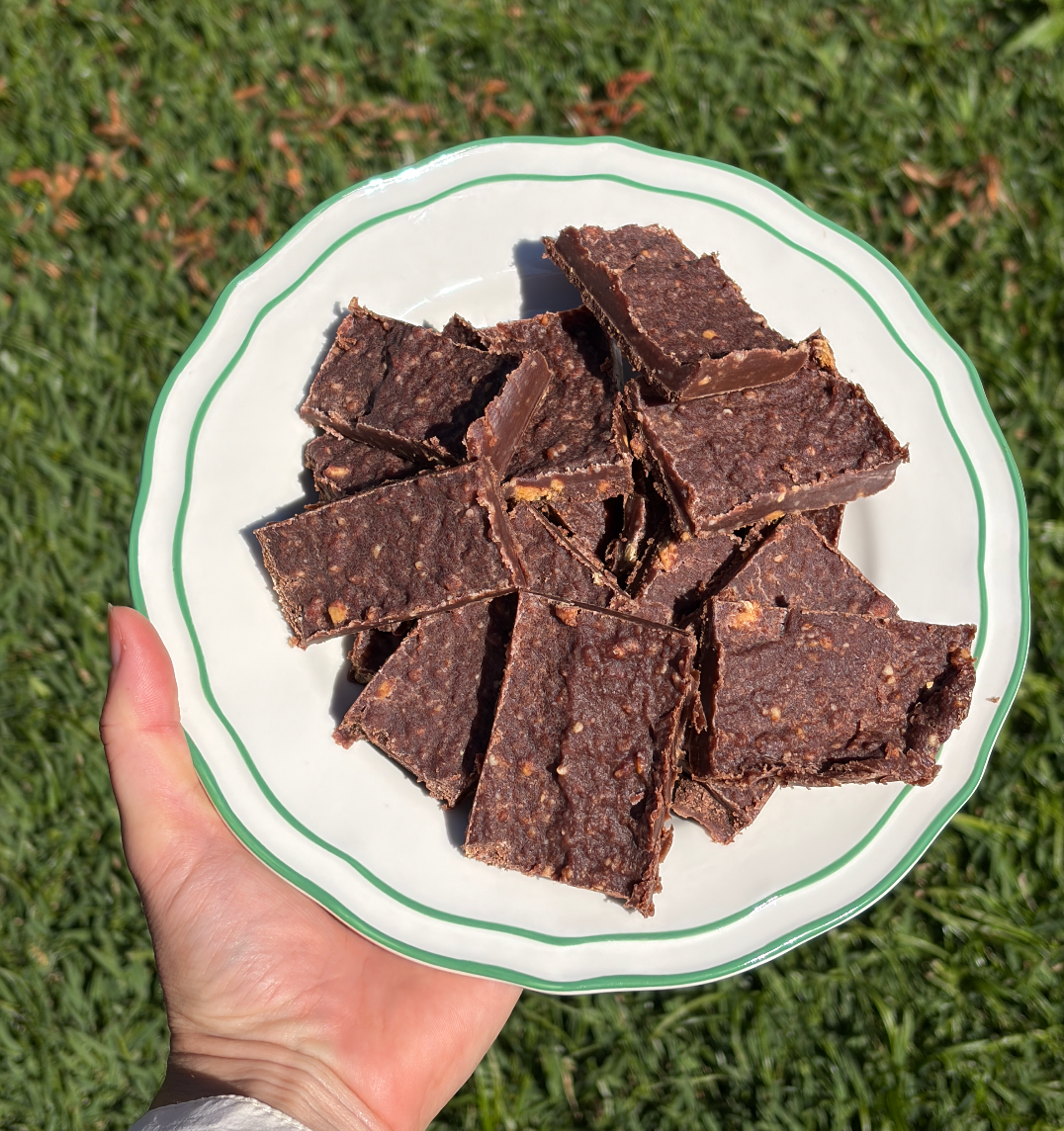 Squares of homemade bone broth cacao chocolate fudge on a white surface